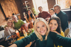 Woman with fresh, youthful face from med spa treatments at her Thanksgiving gathering